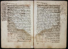 Two pages of a book with writing in Arabic.