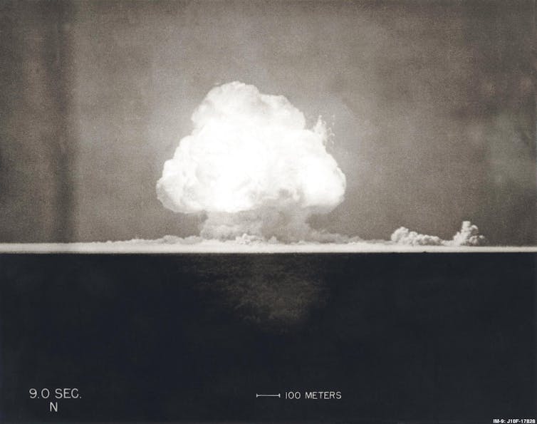 A black-and-white photograph of a mushroom cloud.