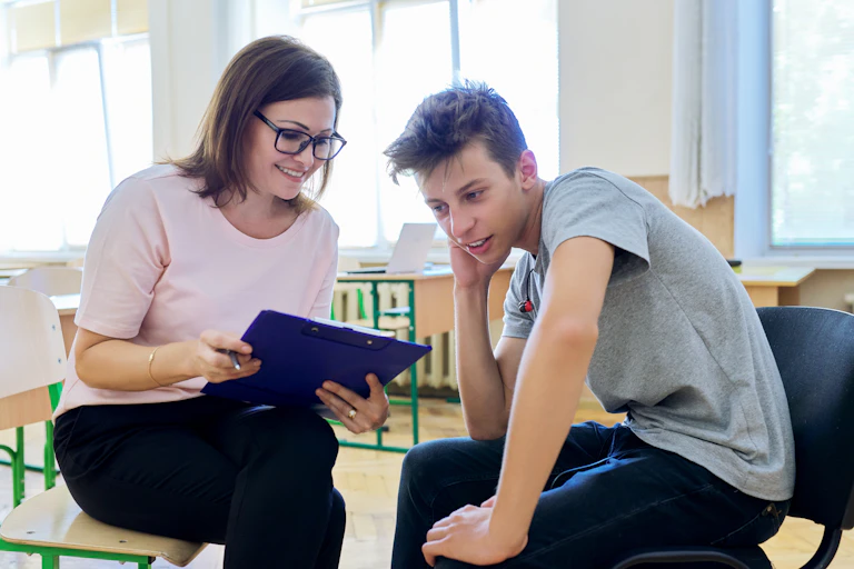 A school nurse runs through a checklist with a student.