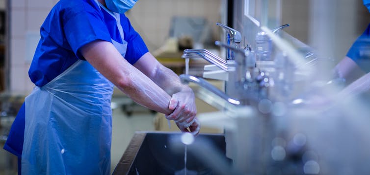 Surgeon washing hands in hospital