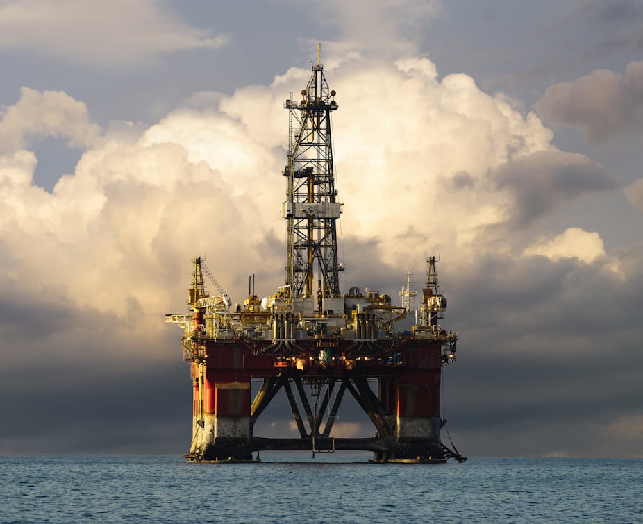 An oil drilling platform against a dark sky.