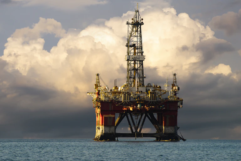 An oil drilling platform against a dark sky.