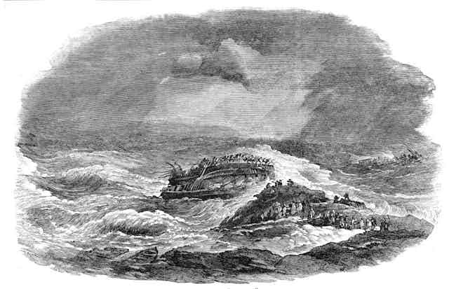 A black and white illustration of a ship wrecked on a rock, with people standing on the rock watching it.