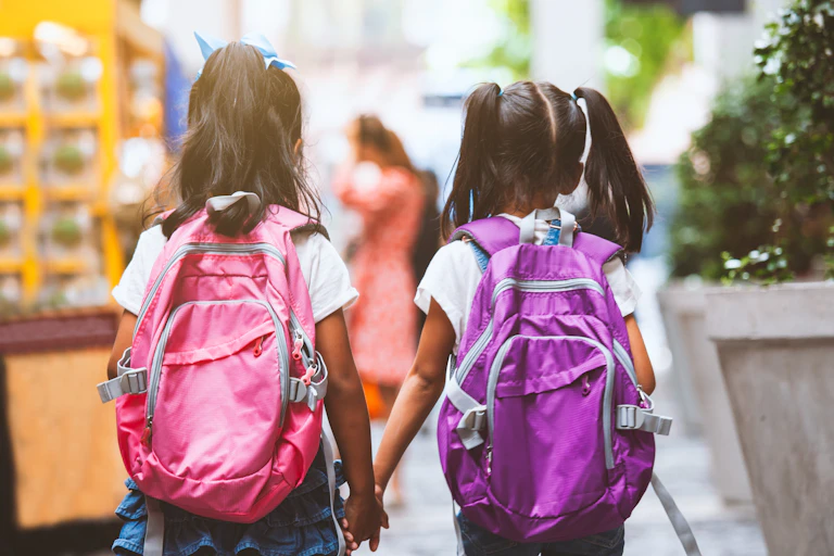 Two children holding hands.
