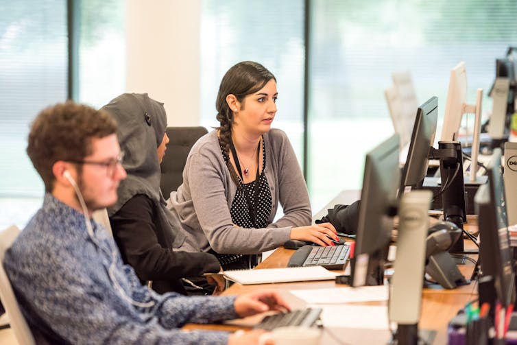 Three people in an office