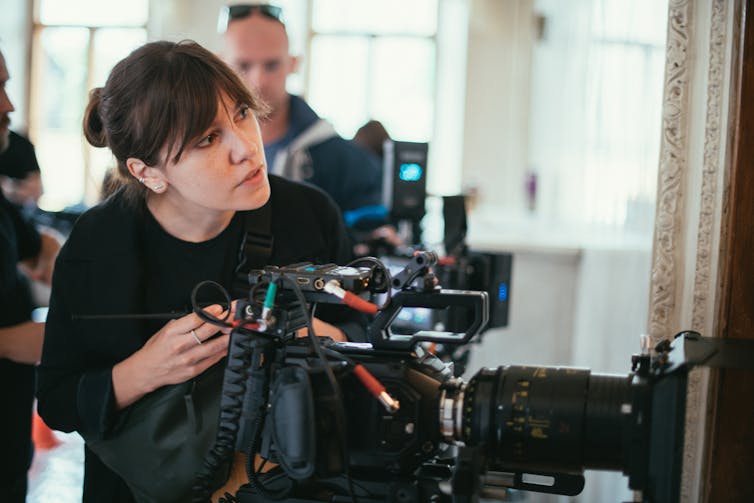 A Woman Behind A Camera.