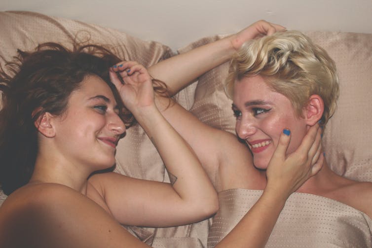 Two women in bed together.