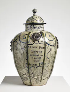 A strange old-fashioned looking vase with a lid.