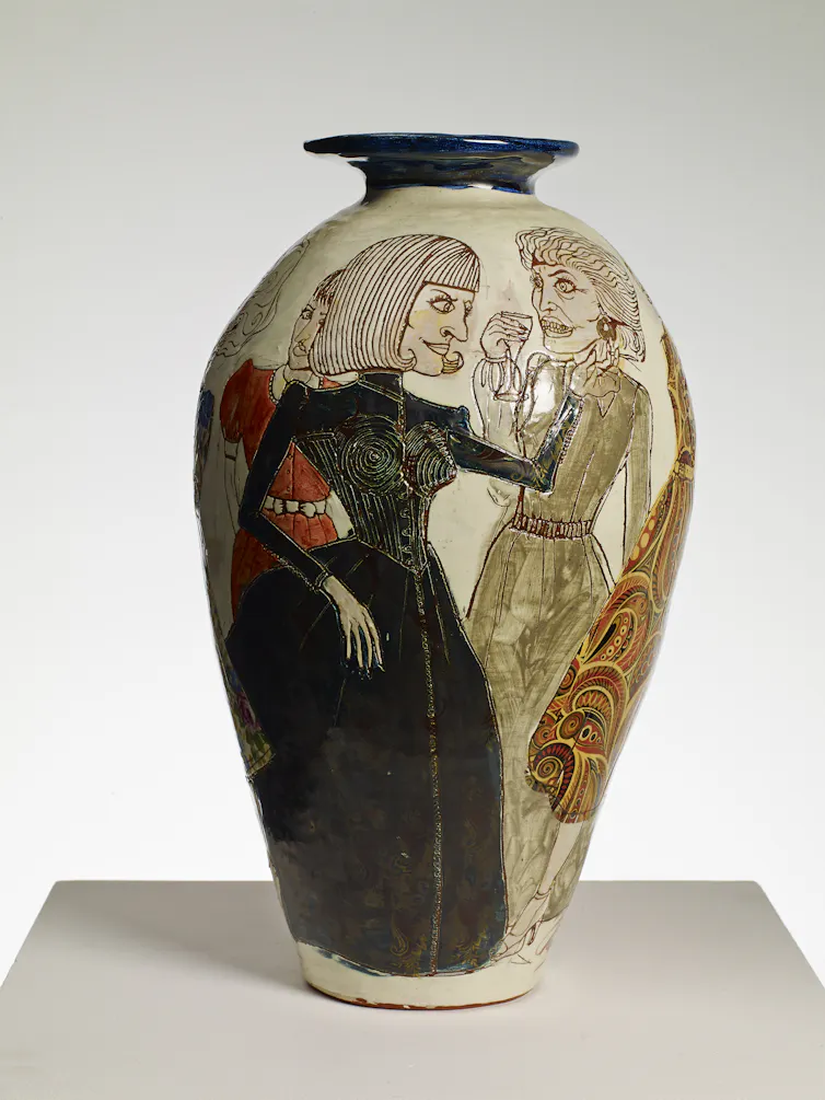 A tall lipped vase showing two women at a cocktail party.