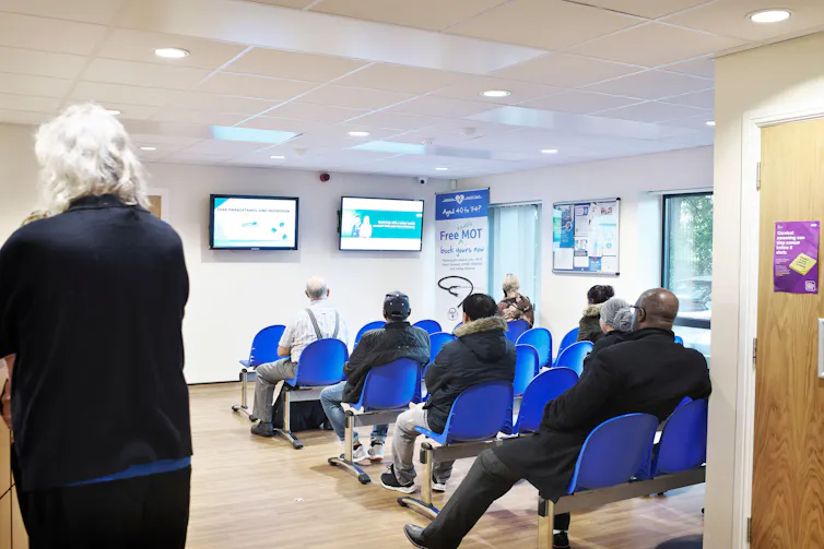 Lots of people in a hospital waiting room