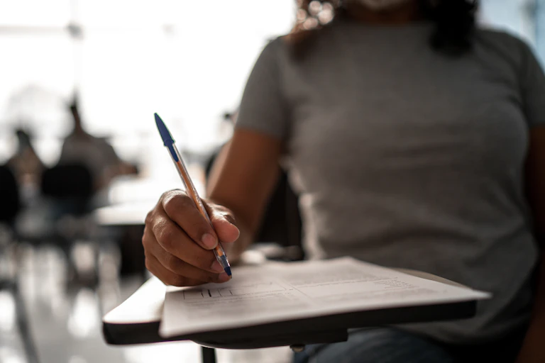 A student takes a survey in a classroom.