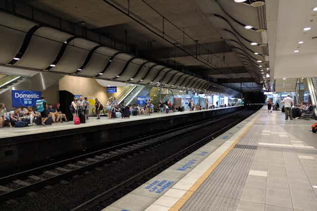 Sydney Airport train station stop with passengers waiting on platform