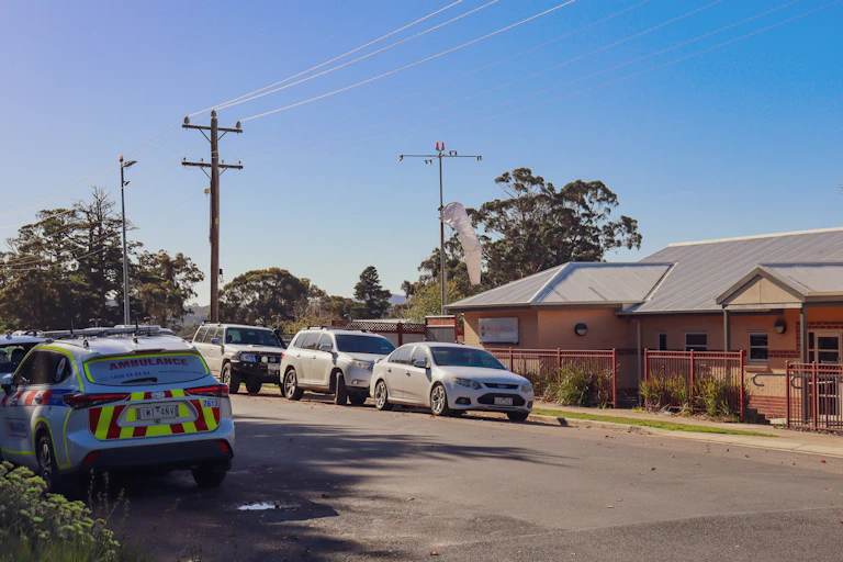 ambulance on country road near small hospital
