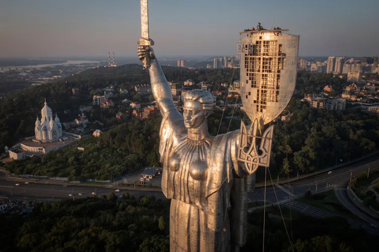 The Motherland Monument in Kyiv, Ukraine with the country's coat of arms on its shield.