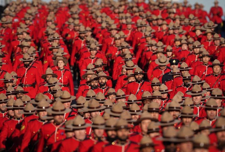 A sea of Mounties in red serge and Stetsons.