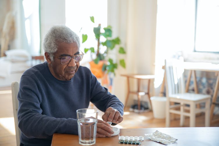 Older man takes medicine