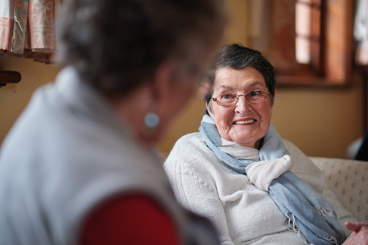 Older woman talks to another woman