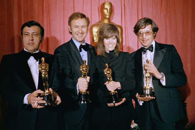 Four people with Oscars