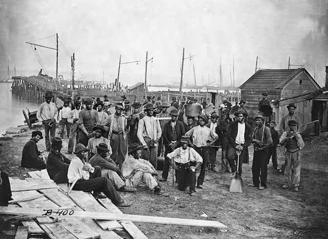 Freed African Americans along a wharf.