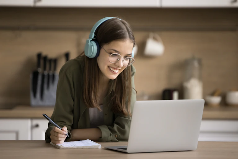 Happy student working on laptop