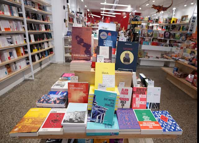 Fiction works arranged on a shelf in a bookshop.