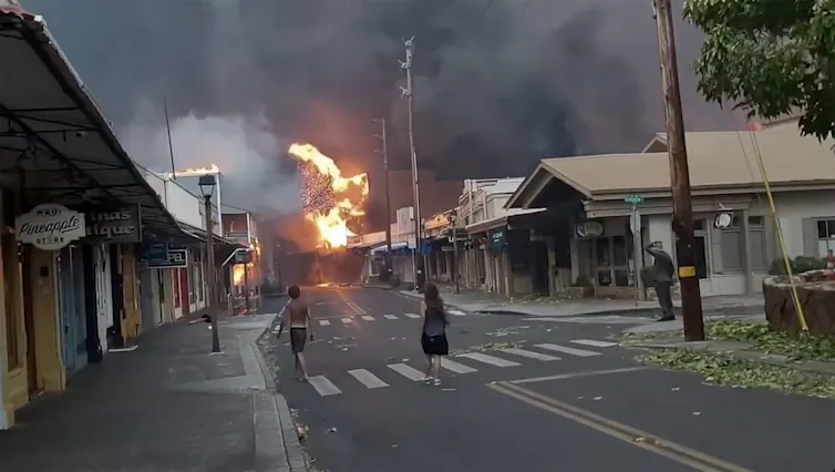 people watch an approaching fire