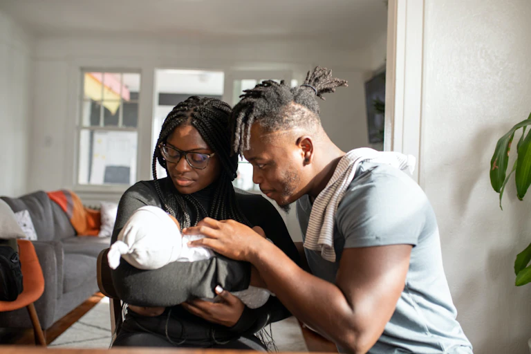 Woman with baby and partner.