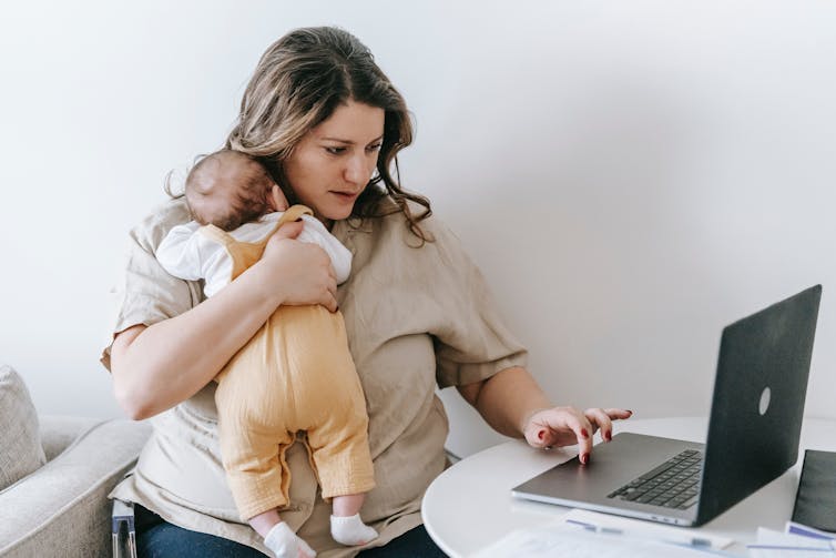 Woman with baby and laptop.