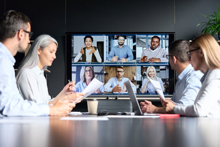 Office boardroom meeting with a Zoom element