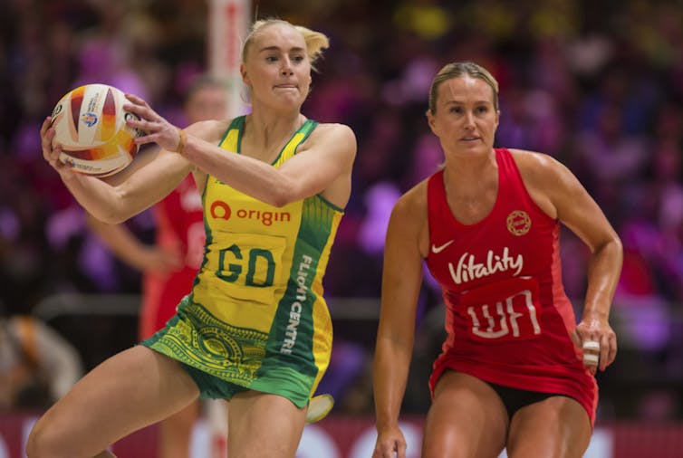 Two women play netball.