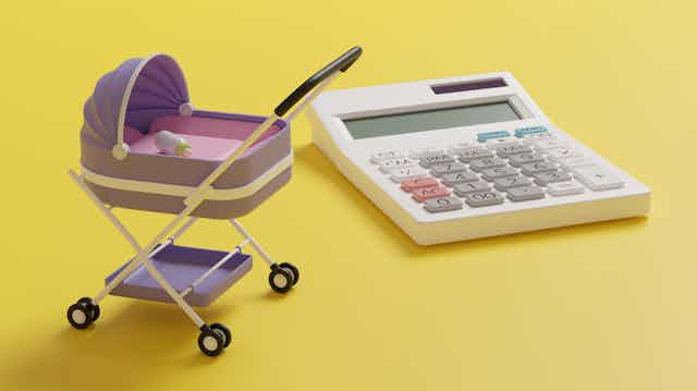 Image of a miniature pram and bottle beside a calculator, yellow background.