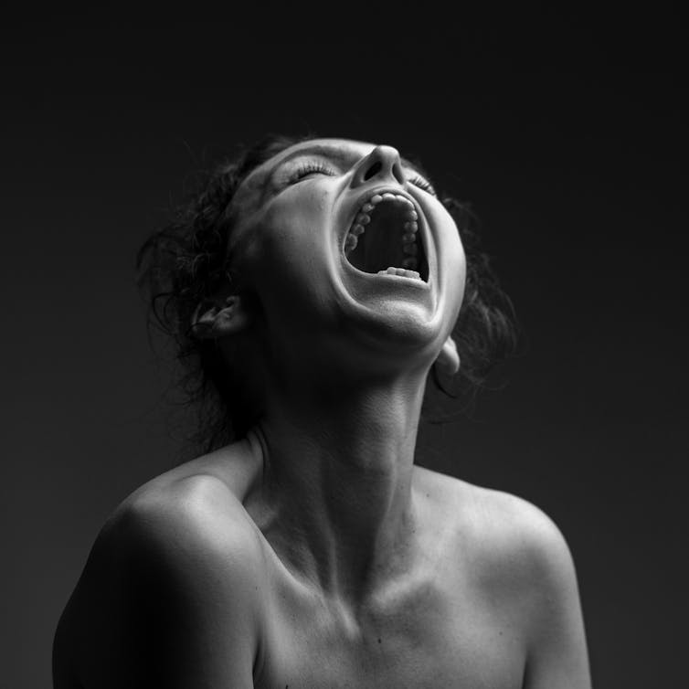 Young woman howling in sadness