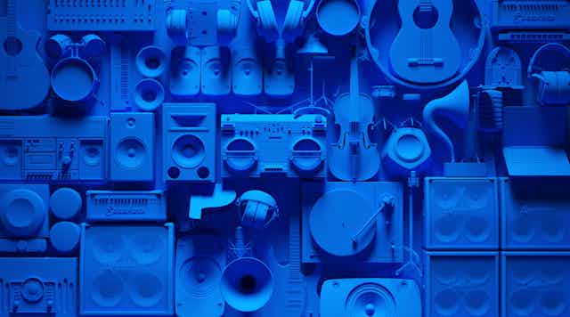Illustration of blue speakers, turntables and various instruments hanging on a wall.