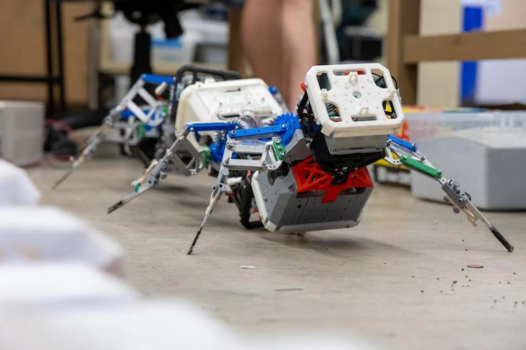 a mechanical device with at least five segments and pairs of legs between the segments