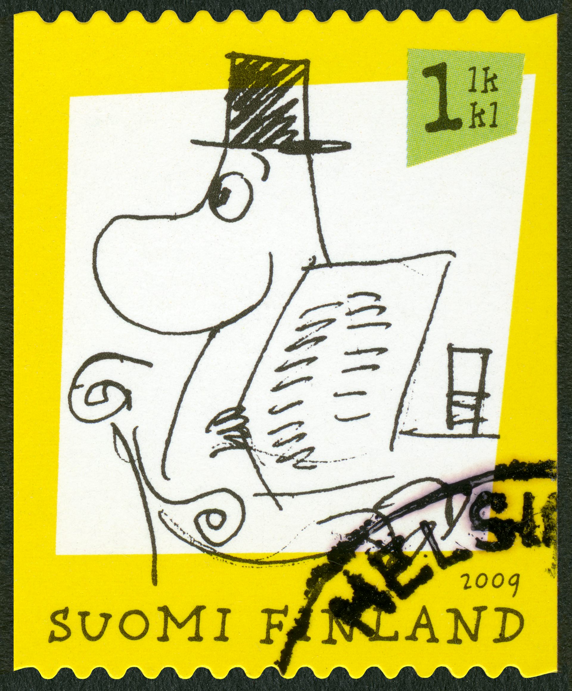 A yellow stamp from Finland with a Moomin character on it wearing a top hat.