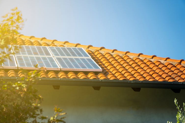 Solar panels on tiled roof of house on a sunny day