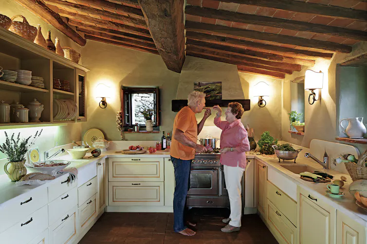 Couple in a large Tuscan villa kitchen