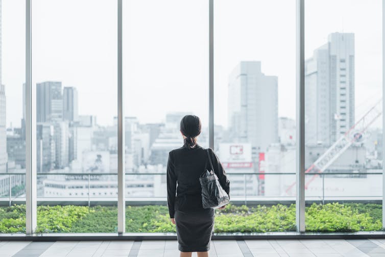A woman office worker in an office setting.