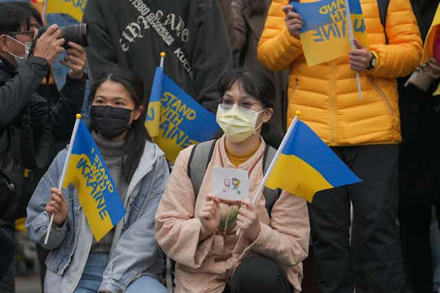 Two women attend a pro-Ukraine rally in Taiwan
