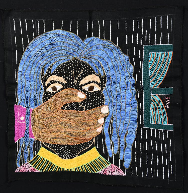An embroidery depicts a woman with blue hair, her eyes wide and frightened and her mouth covered by another person's hand