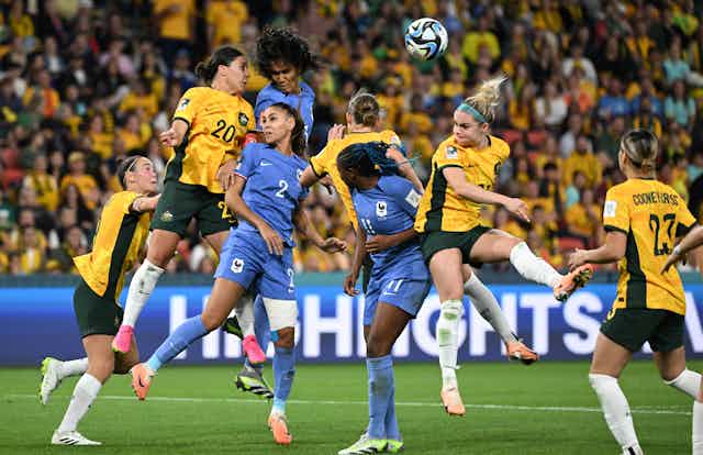 Players jumping for a header during the quarter final between Australia and France
