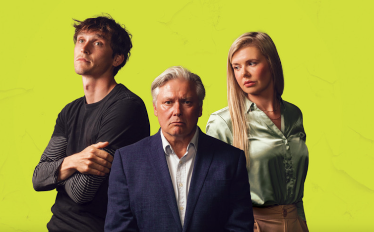 A young man and a young woman standing next to a seated older man in the middle against a yellow background.