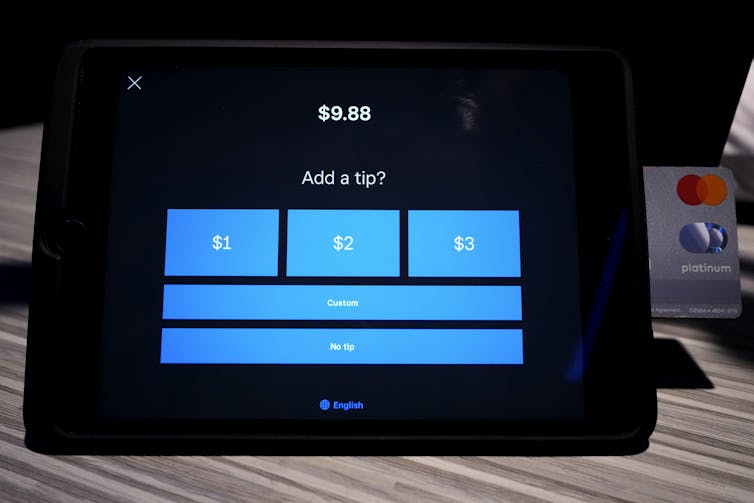 A card reader tablet with tip options that are for $1, $2 and $3, custom or no tip