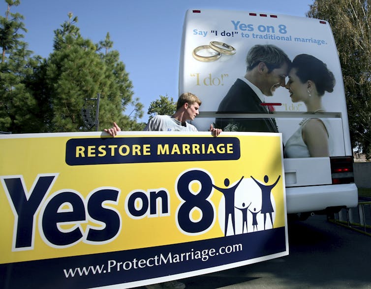 A large yellow and black banner that says'Restore marriage Yes on 8'