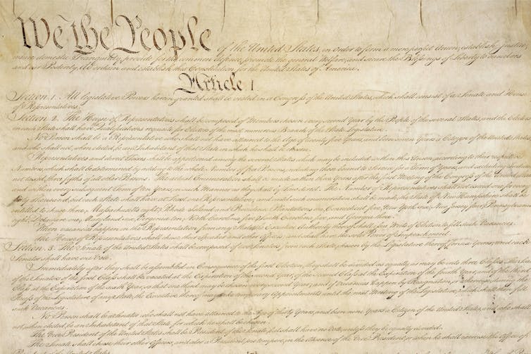 An old document that begins with 'We the People.'