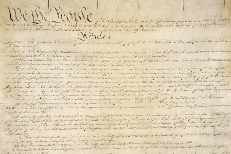 An old document that begins with 'We the People.'