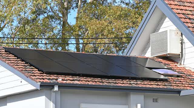 Roof with solar panels and air con unit