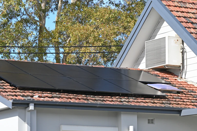 Roof with solar panels and air con unit