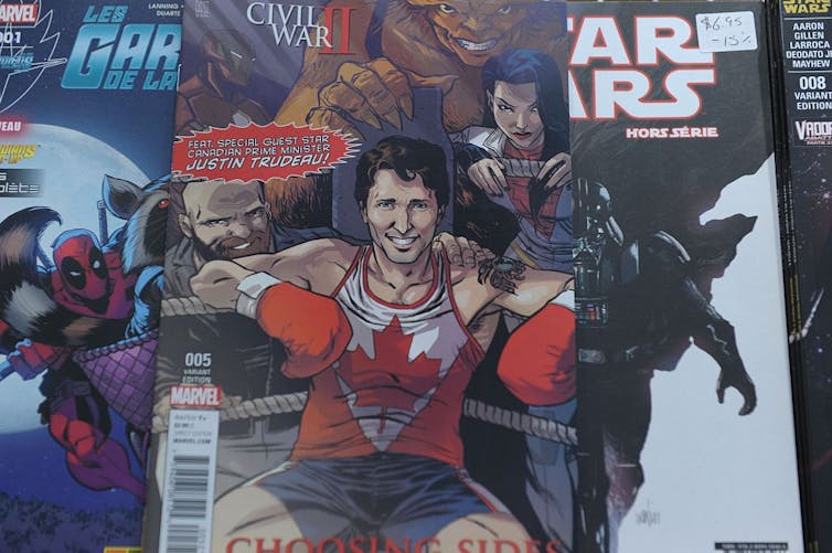 Cover of comic book depicts smiling man sitting in corner of boxing ring wearing boxing gloves and a red and white pinny with a maple leaf logo.