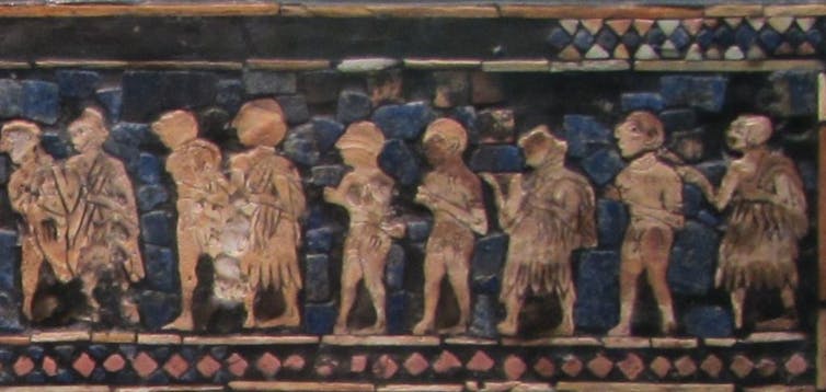 A faded blue tile shows tan-colored figures walking in a line.